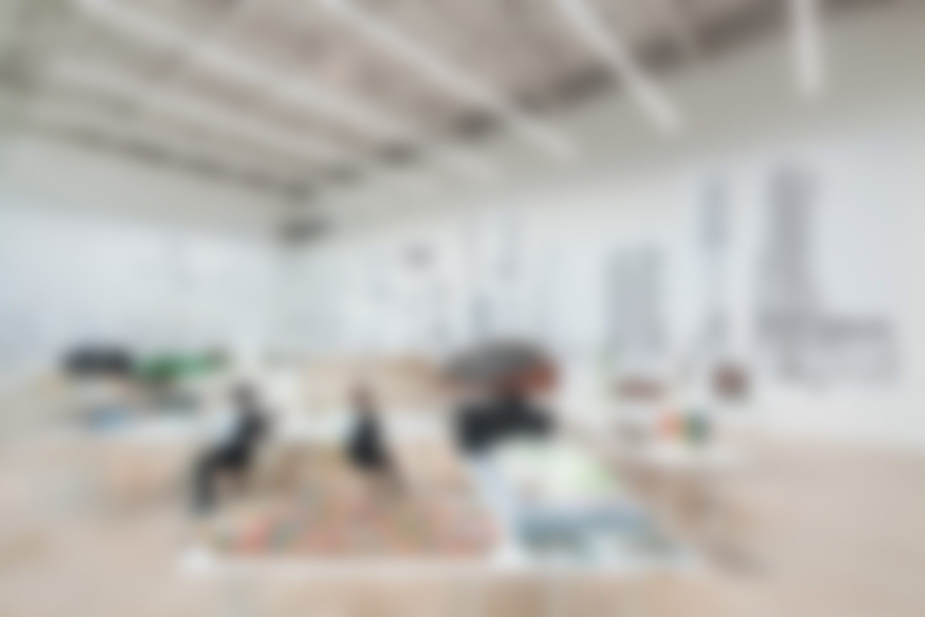 Blurry art gallery interior with abstract paintings