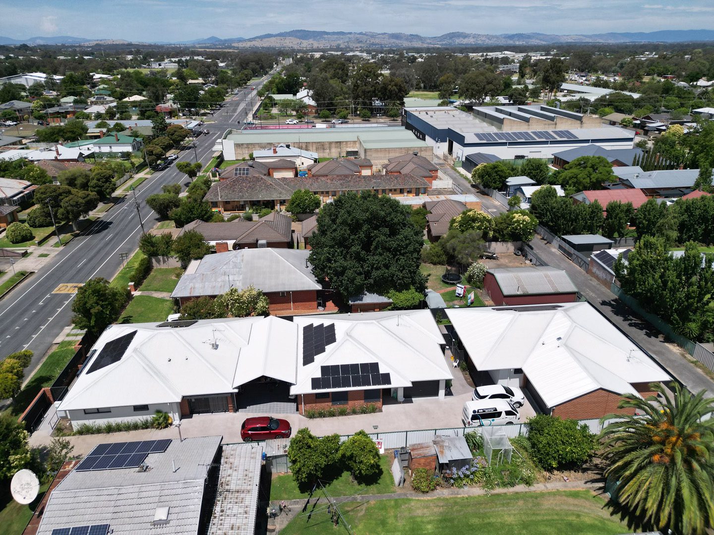 Aerial view of suburban neighborhood with solar panels