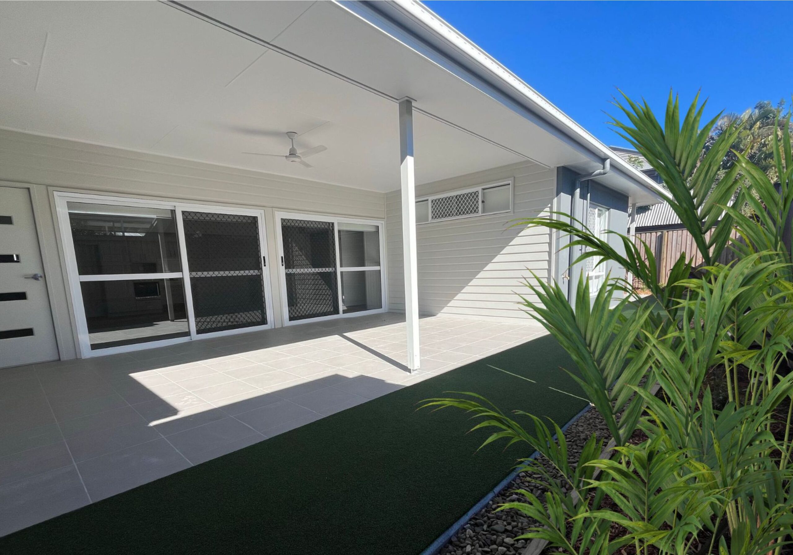 Modern patio area with green artificial grass