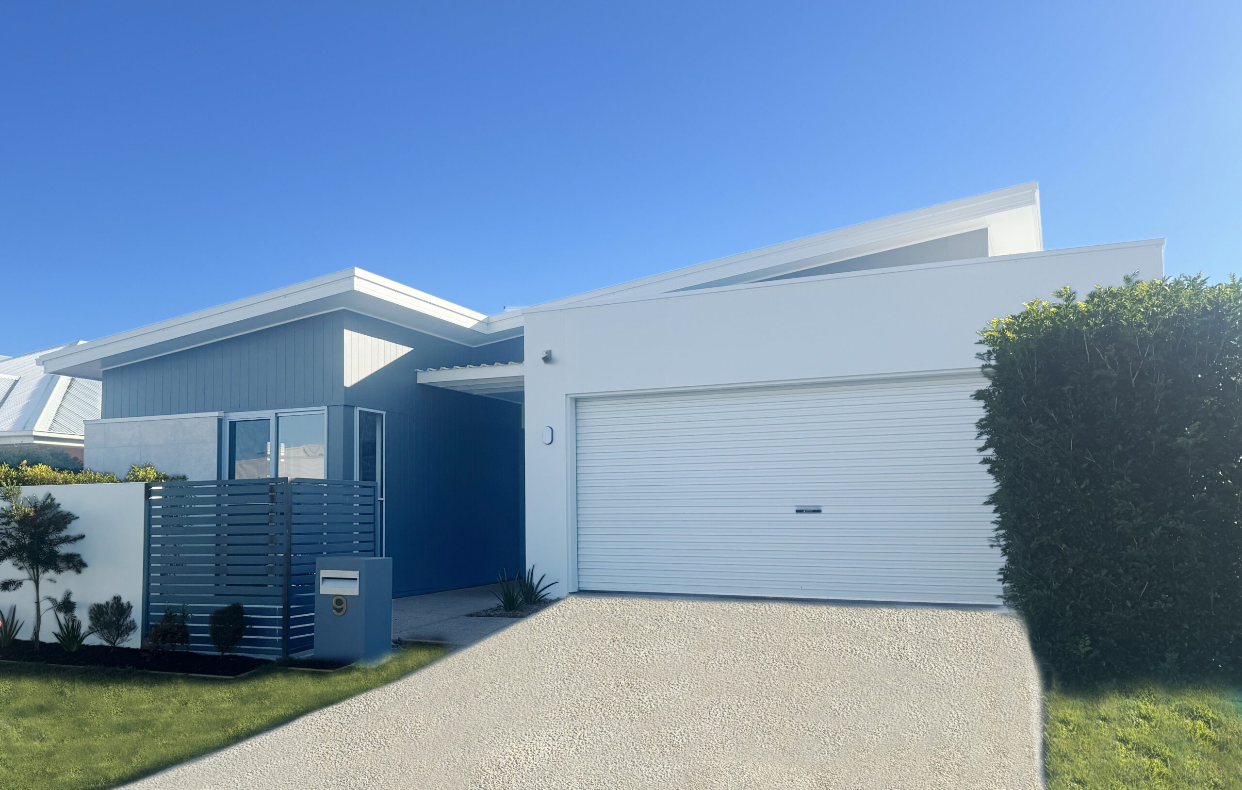 Modern white house with attached garage exterior