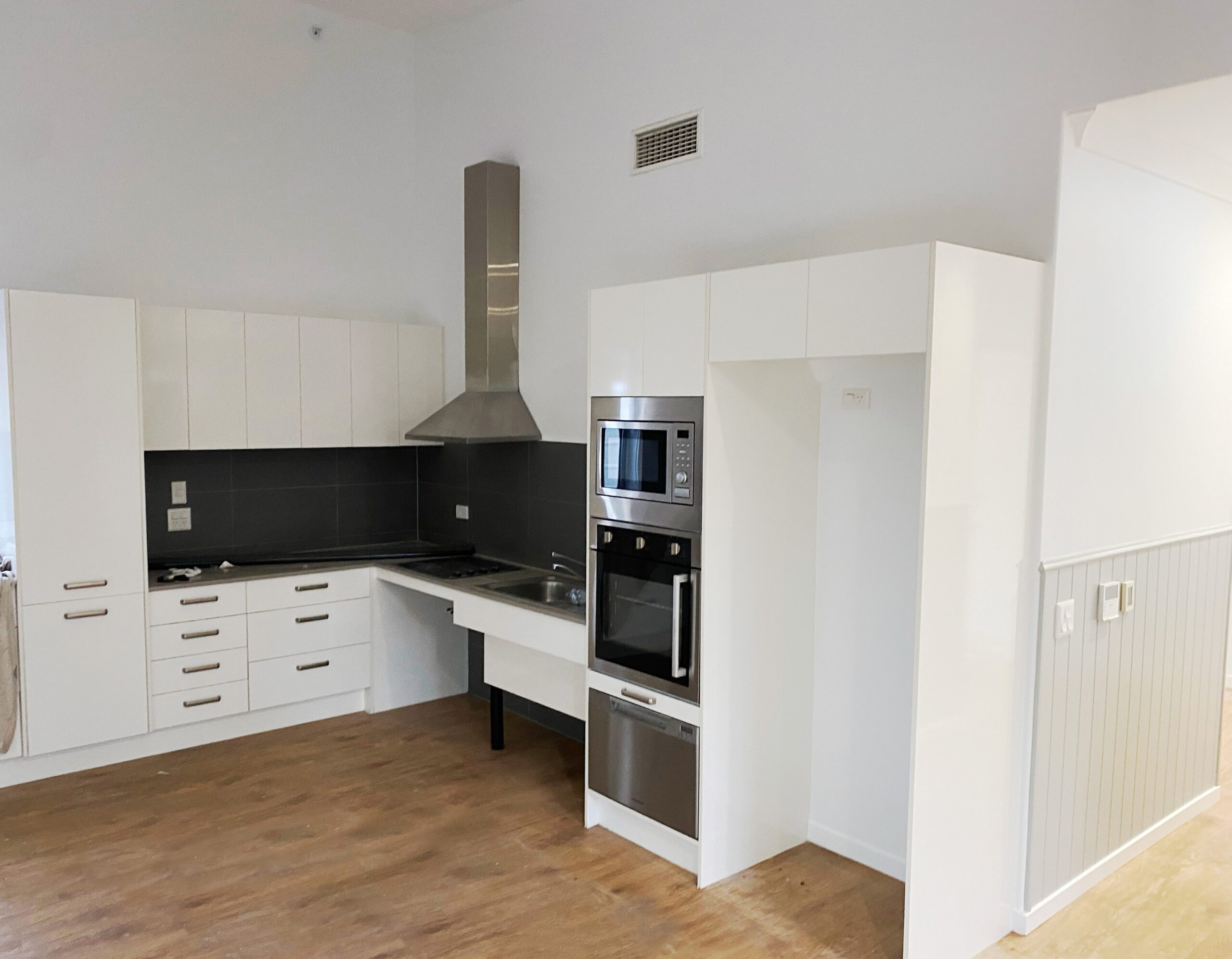 Modern kitchen with white cabinets and appliances