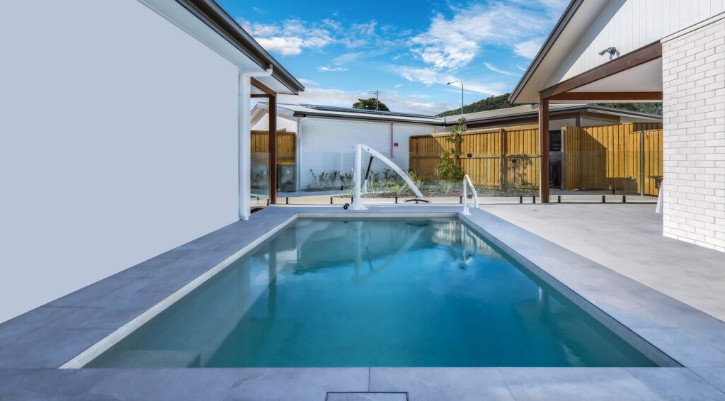 Modern backyard swimming pool with clear water