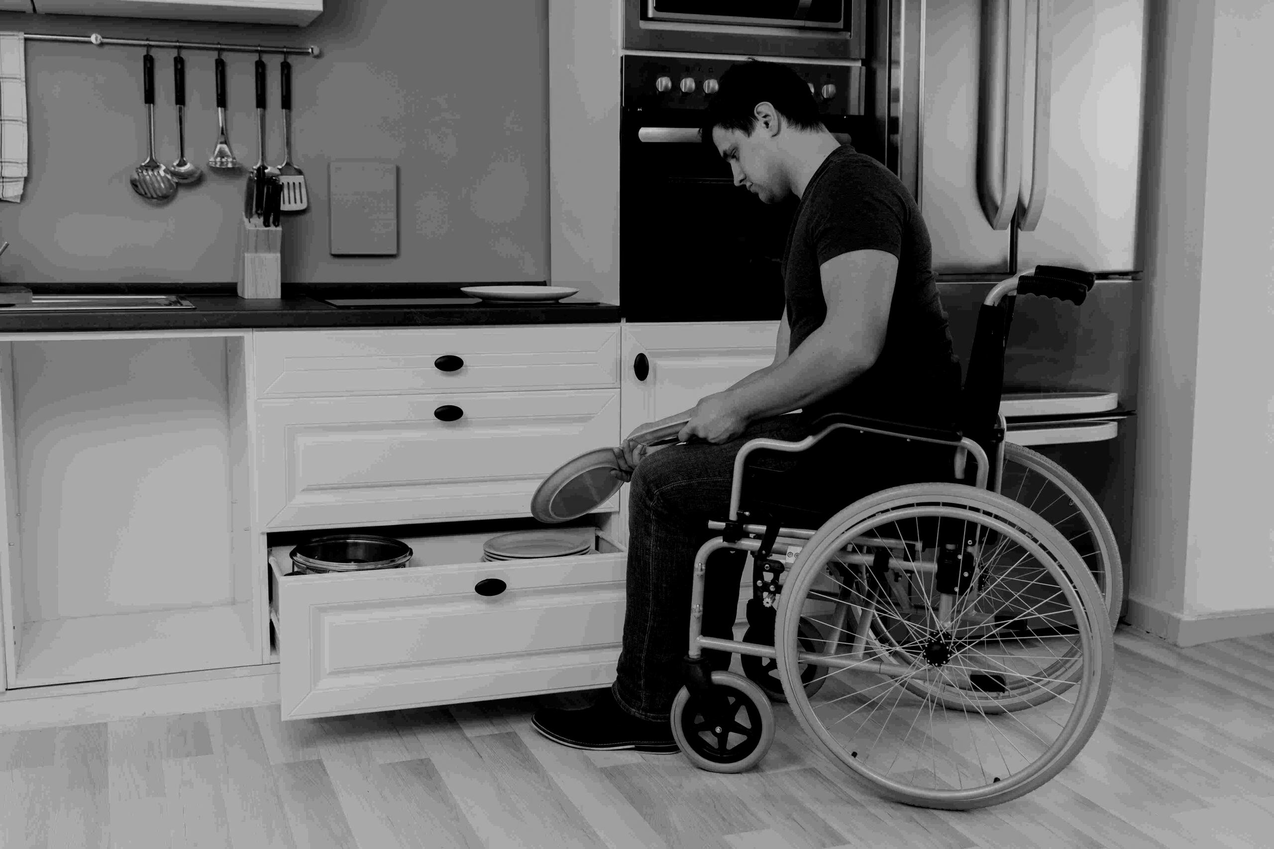 Guy on a wheelchair opening a drawer